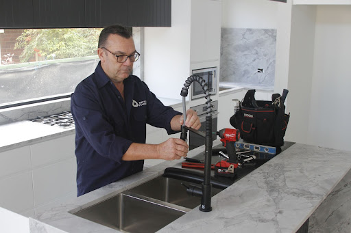 our plumber fixing the kitchen sink tap beaconsfield plumbers